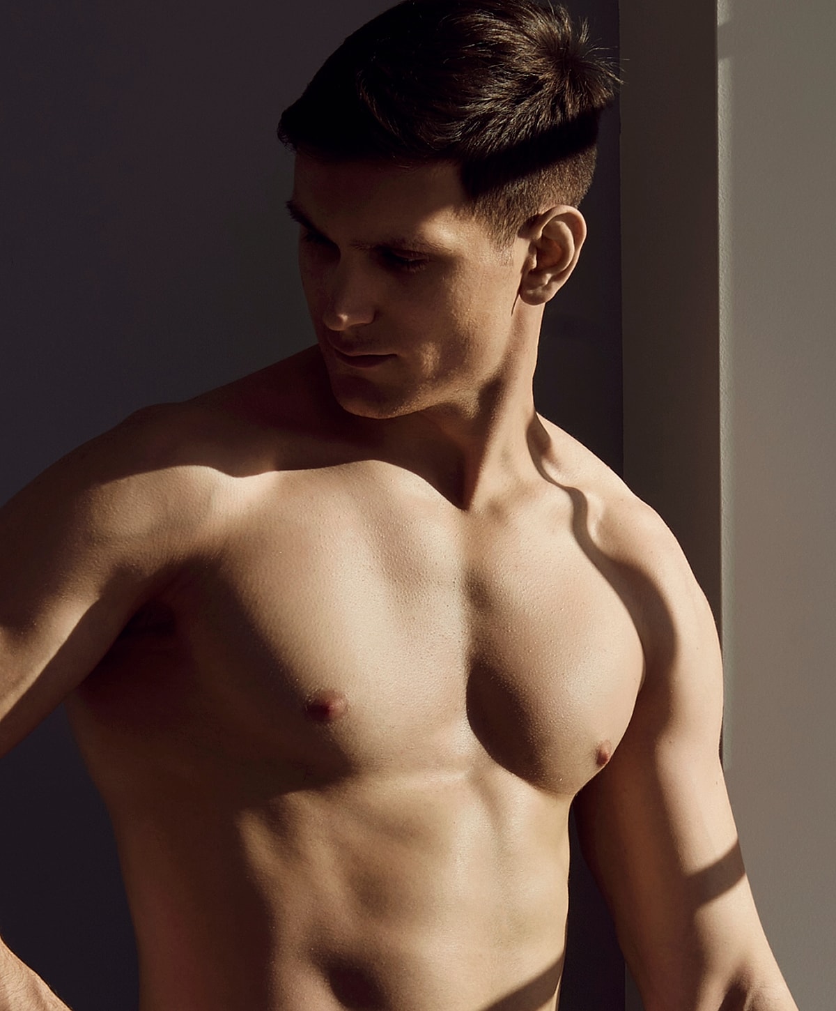 Male model posing in soft natural light.