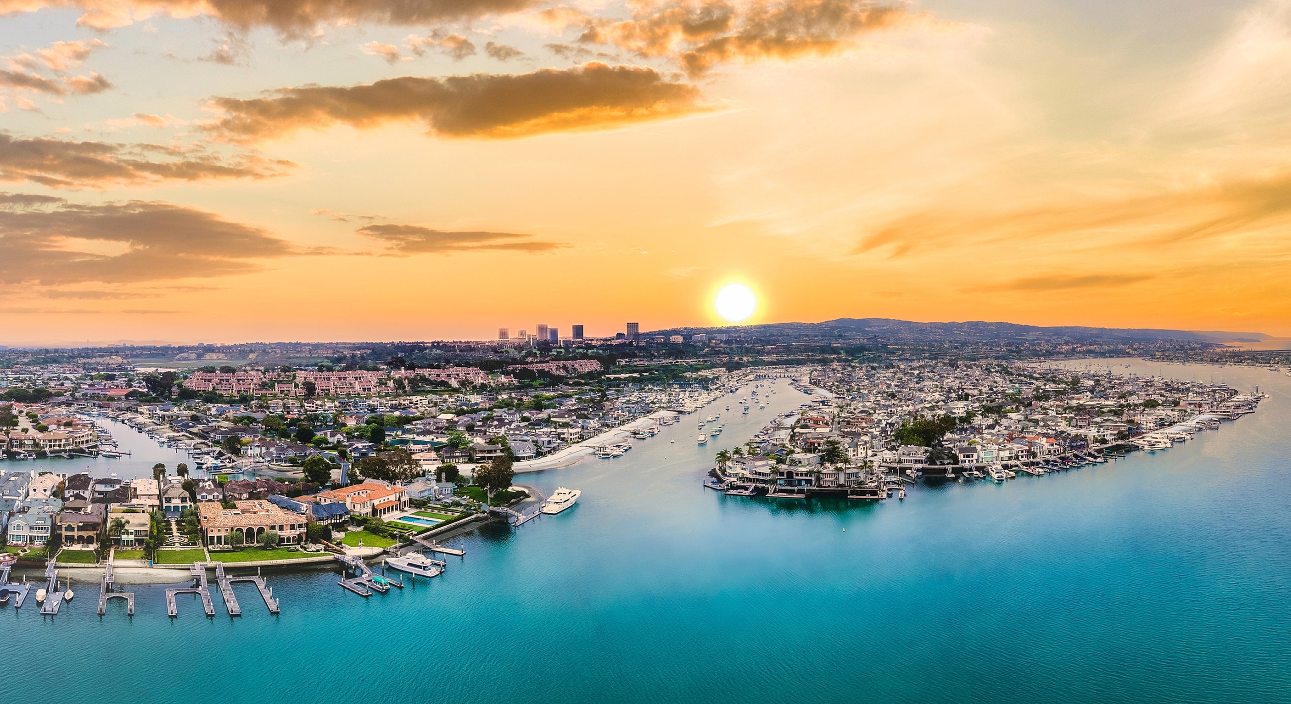 Aerial view of vibrant coastal sunset landscape.