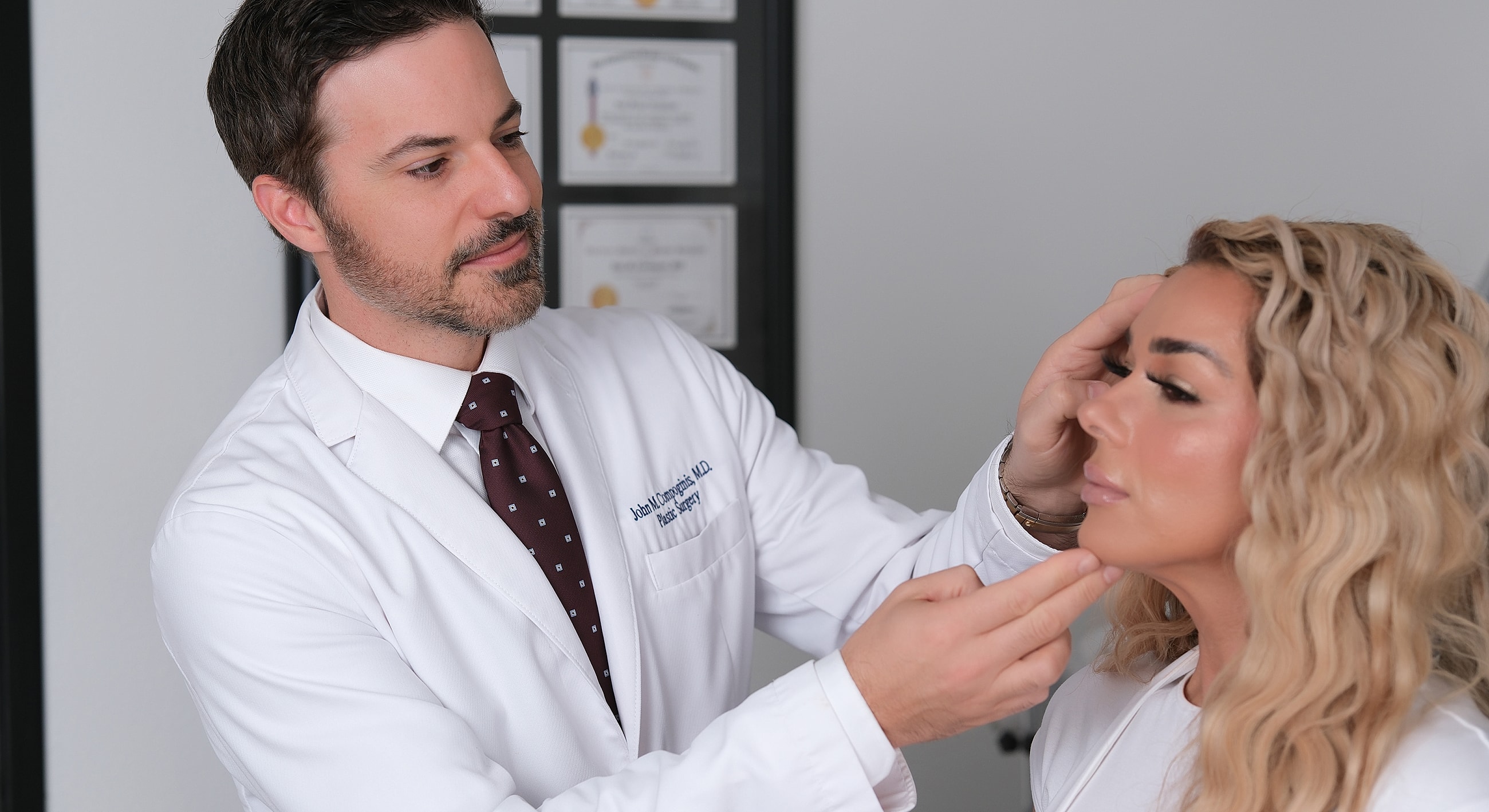 Doctor examining patient's face in office setting.